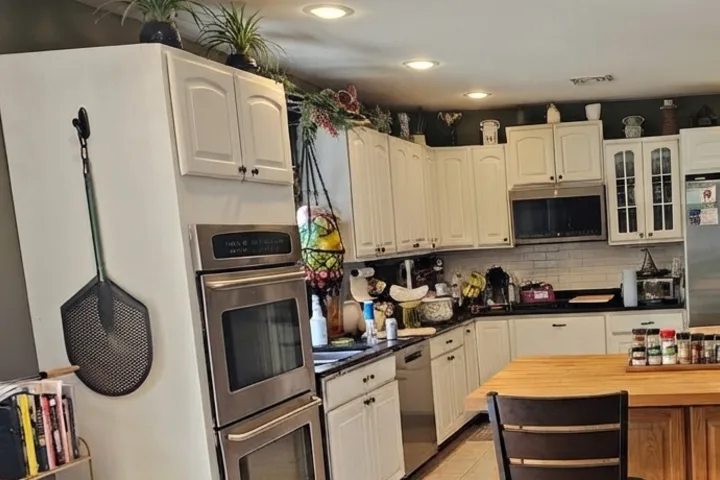 Existing white cabinets and appliances retained around the new island concept