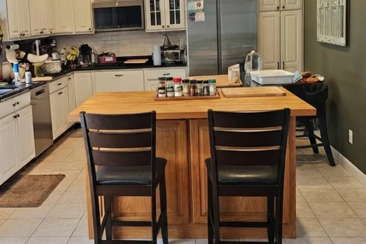 Rectangular natural-wood island in the AI kitchen design concept