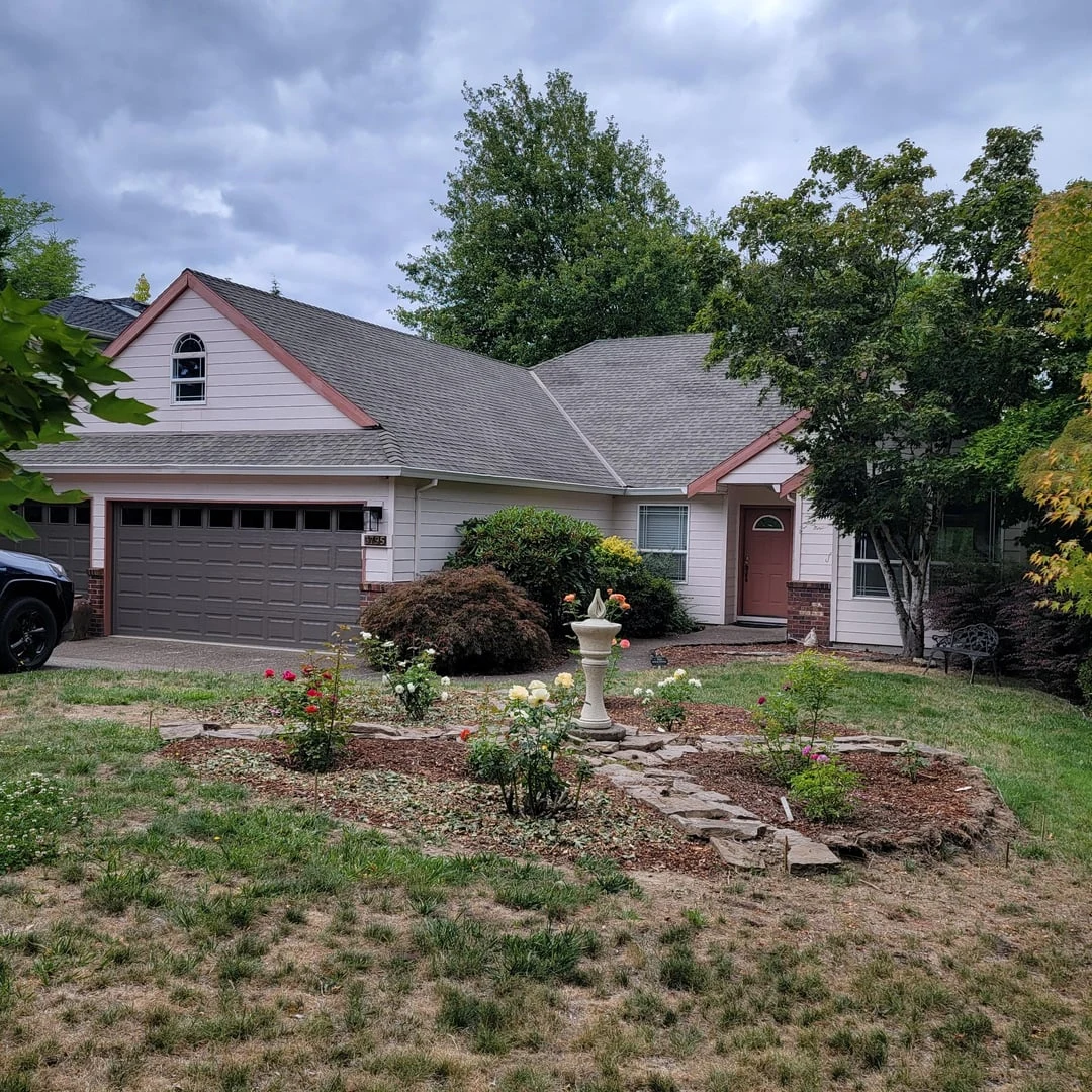 Original public Reddit gallery photo of a white-sided house with muted red trim and a gray roof